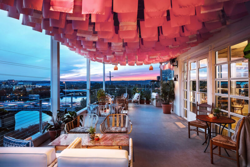 P6 - outdoor patio with pink textiles hung from the ceiling