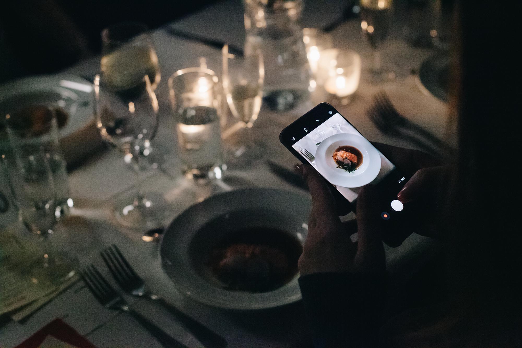 Cover Image for Picture of someone taking a picture of their food on their phone