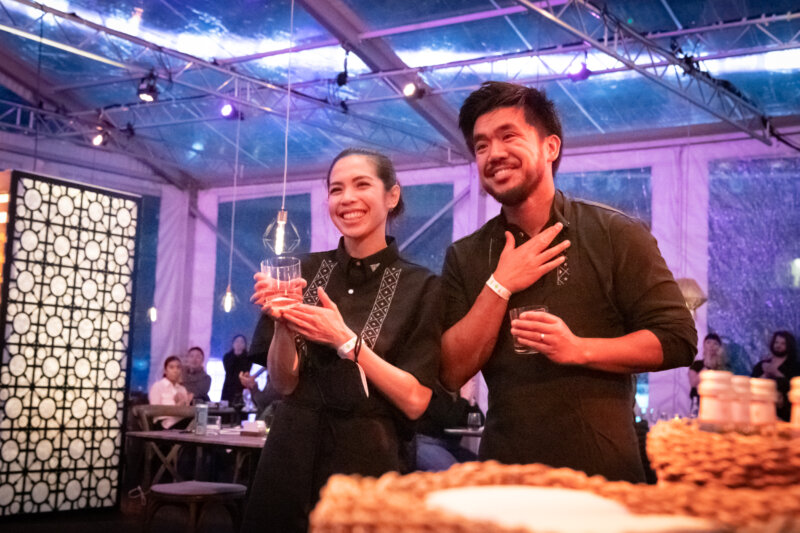 Image of Aaron Verzosa and Amber Manuguid of Archipelago in Seattle inside the Field to Table tent. 