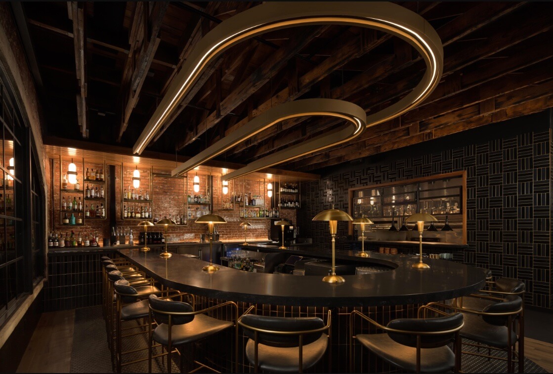 Cover Image for Interior bar shot of Rare Society. The bar has black and gold accents