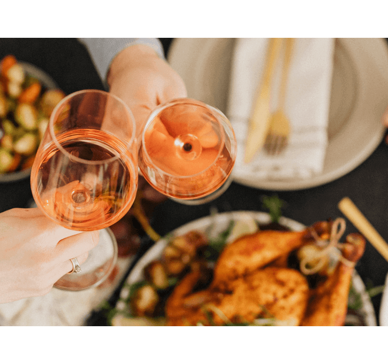 Cover Image for glasses with orange wine and roasted poultry in the background