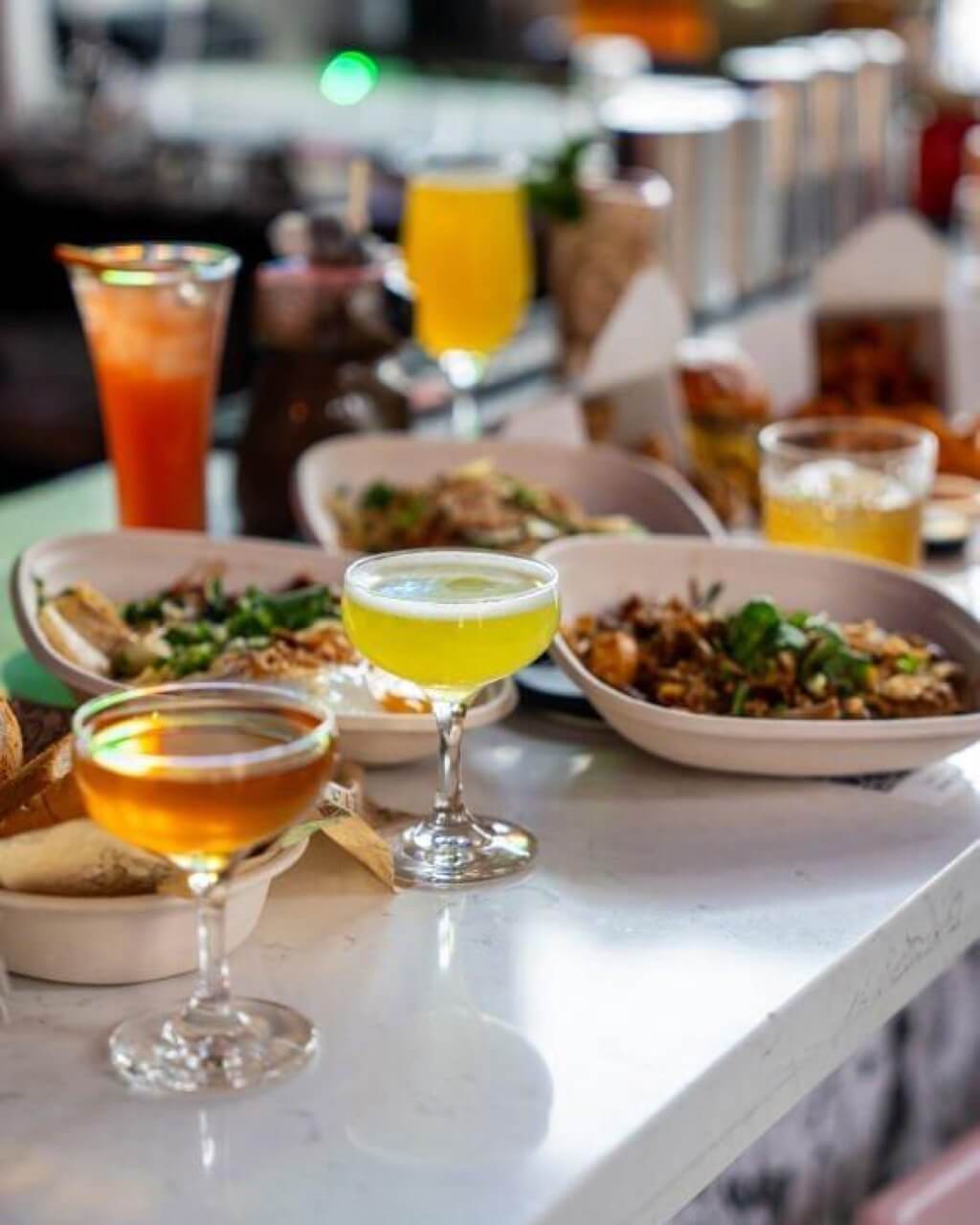 Spread of food and drinks on a bar counter