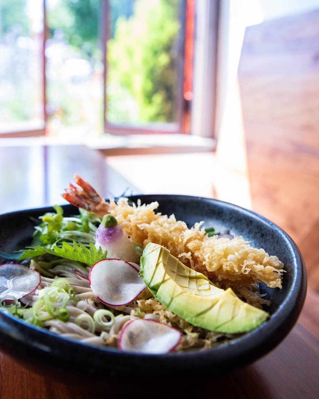 Soba noodle dish with scored avocado and tempura shrimp