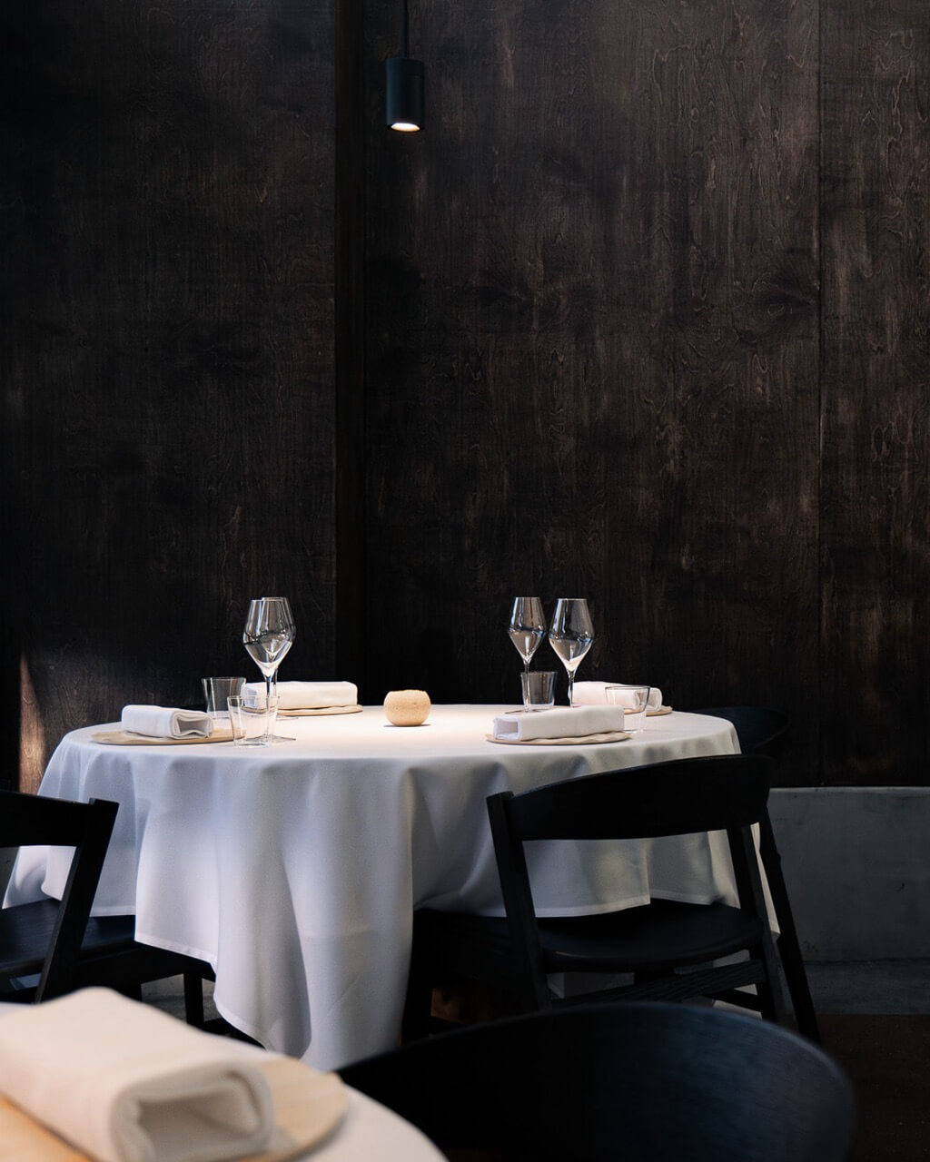 Table setting at Kiln with white tablecloth