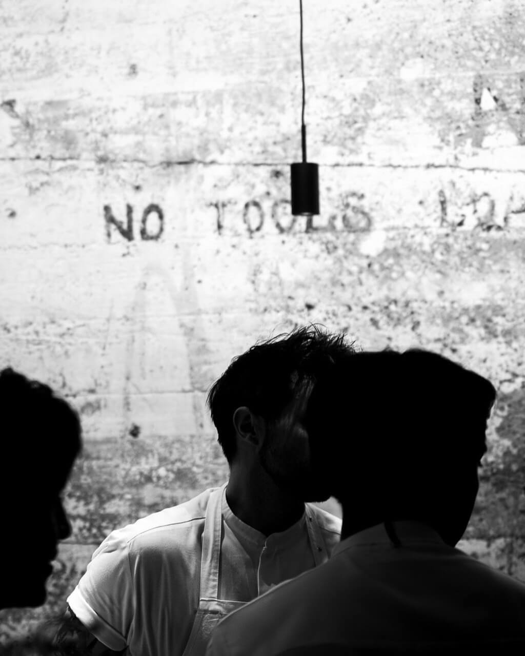 Silhouette of chefs against an industrial concrete background