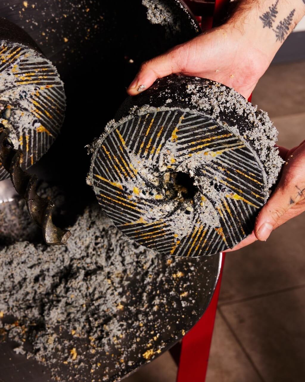 Hands holding a masa grinding stone