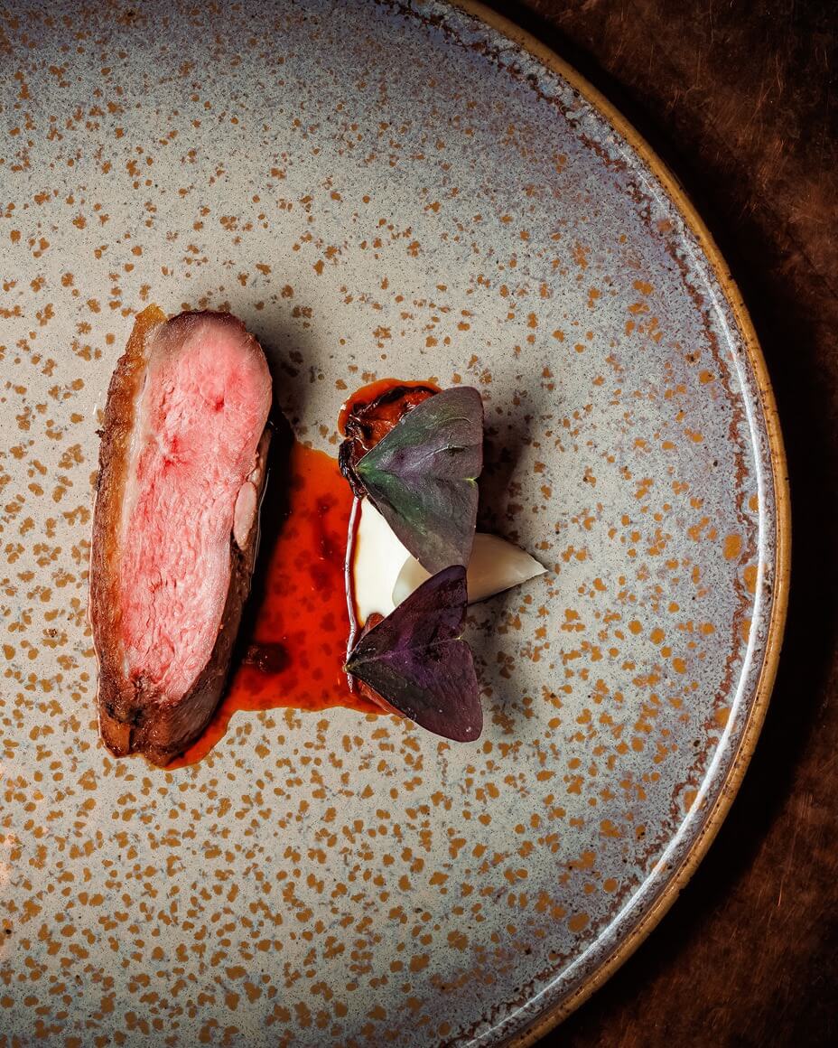 Beautifully meat dish plated on speckle glazed pottery