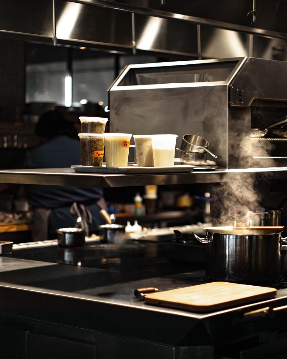 Kitchen with cook prepping in background
