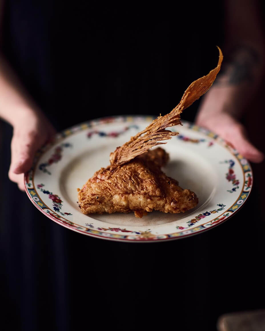 Fried fish collar dish being held on an ornate plate