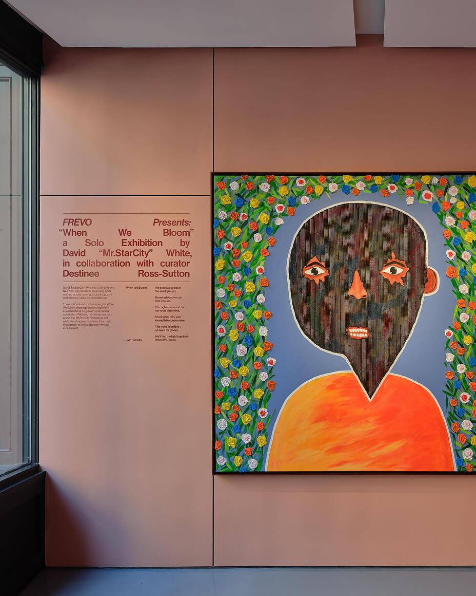 Label and description for “When we Boom” next to a painting from the exhibition in FREVO’s gallery