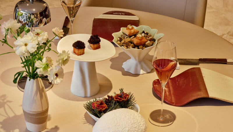 Table setting with three plates of small bites elegantly plated