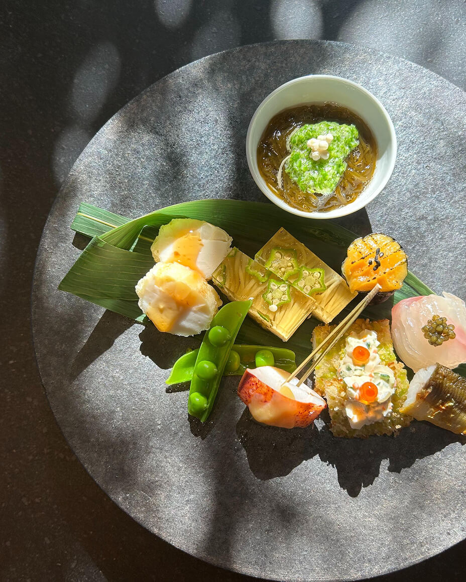 Plant shadow on gray stone plate with colorful ingredients