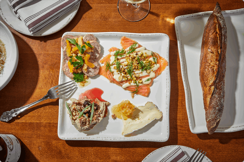 Charcuterie spread with a baguette at Dear Margaret