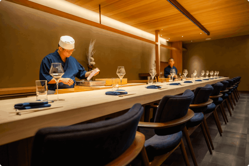 Chef Shingo Akikuni and another employee behind the counter at SHINGO