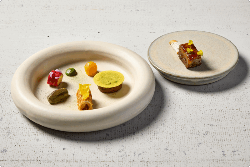 Two circular plated dishes with vibrant colors